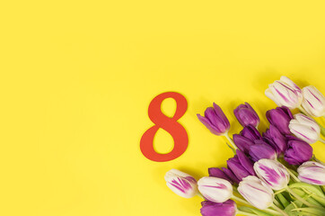Tulips in a gift bag on a yellow background. Postcard for March 8, Mother's Day, birthday. Flower delivery. Flower Shop. Space for text