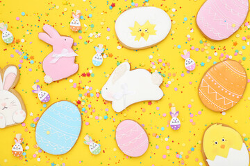 Easter gingerbread cookies with colorful sprinkles on yellow background