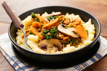 Lentil Stew with kale, carrots and mushrooms on mashed potatoes.