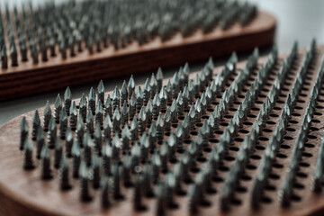 A wooden sadhu board with sharp nails for sadhu practice. Alternative medicine. Macro. Closeup