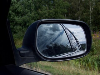 Fototapeta na wymiar rearview car driving mirror view green forest road