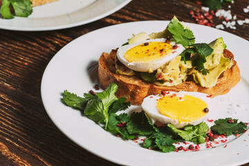 Poached egg and avocado  on sliced toasted bread