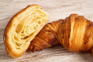 Fresh baked croissants. Freshly baked croissants on wooden table. Close up