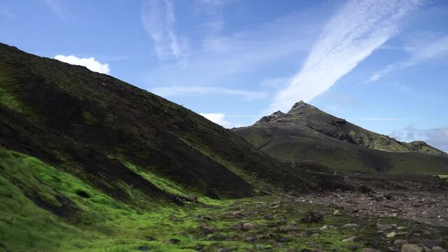 Green field with moss and mountain peak on the Laugavegur hiking trail, Iceland