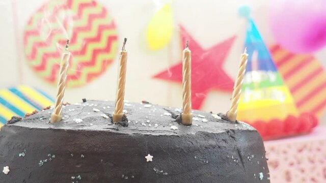 light candles on a cake happy  girl celebrates birthday, eats cake, balloons and decorations. the candles on the cake blow out. 