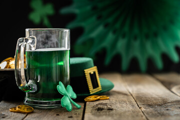 St. Patricks day concept - green beer and symbols, rustic background. Part invitation.