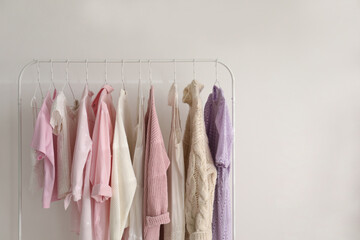 Rack with stylish women's clothes indoors, space for text. Interior design