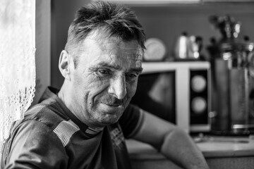 A man farmer in his rural home. Black and white photo.