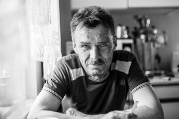 Portrait of a man farmer in his rural home. Black and white photo.