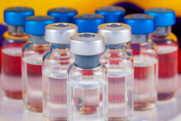 Vaccine vials and Colombian flag. Vaccination concept.