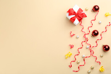 Flat lay composition with serpentine streamers and Christmas decor on beige background. Space for text