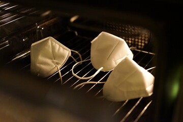 face masks in oven, view from outside, door opened