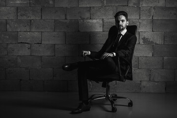 Black and white portrait. Businessman, serious and business man with a beard in a dark suit and...