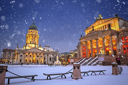 Snowy illuminated Gendarmenmarkt at night in Berlin, Germany