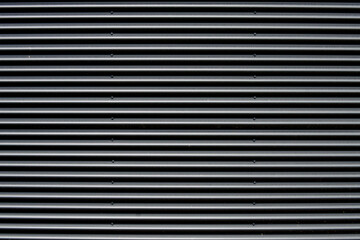 Plain dark corrugated galvanized metal garage door, panel or wool