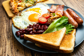 Rustical breakfast eggs, sausages, vegetables. Selective focus