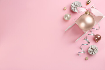 Beautiful Christmas composition with miniature sleigh on pink background, flat lay. Space for text