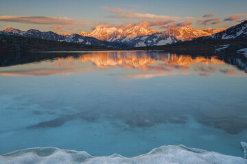 Spring Sunset with the Peaks Reflected in the Alpine Lake, Stelvio National Park, Lombardy, Italy 