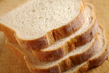 slices of white bread on a wooden cutting board