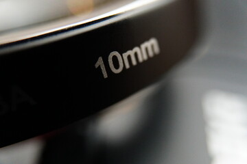 Macro closeup of 10mm zoom lens extension for camera.