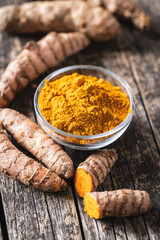 Indian turmeric powder and root. Turmeric spice. Ground turmeric.