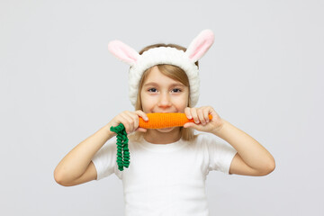 Portrait of a cute baby dressed in bunny ears with a carrot