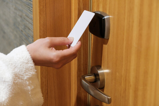 Close up woman hand opening a door by key card in the hotel. 