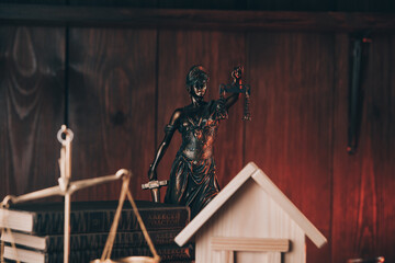 Miniature House and lady of justice. Auction or law concept.