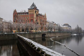 Bellevue house in the style of the Dutch renaissance and Smetana Museum at Smetana embankment, Old town and Vltava river, snow in winter day, Prague, Czech Republic