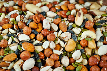 Many types of nuts close up. Textures of different nuts. Nuts are dumped in a pile.