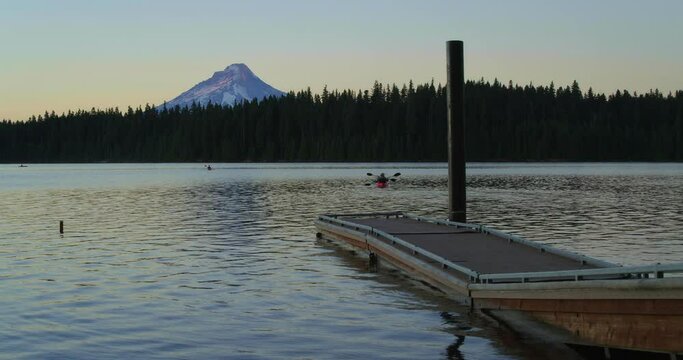 People Kayak On Timothy Lake With Mt. Hood In Distance At Sunset, Wide