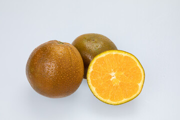Citrus fruit (rangpur) with water drops isolated on white background