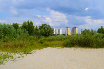 View through the sand to houses in the distance near nature