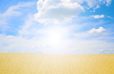 Fototapeta na wymiar White sun over the desert in the sky with white clouds