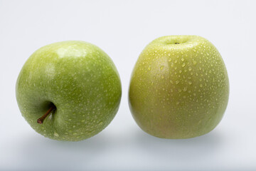 Green apples with water drops, isolated on white background