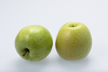 Green apples with water drops, isolated on white background