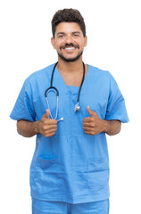 Optimistic mexican male nurse at work