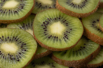 Background with sliced juicy kiwi with black seeds