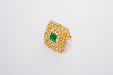 GOLD RING WITH EMERALD AND SMALL POLKI STONE ON WHITE BACKGROUND
