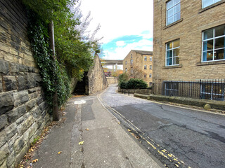 Fototapeta na wymiar View along, Old Lane, with stone steps, walls, and Victorian buildings in, Halifax, Yorkshire, UK