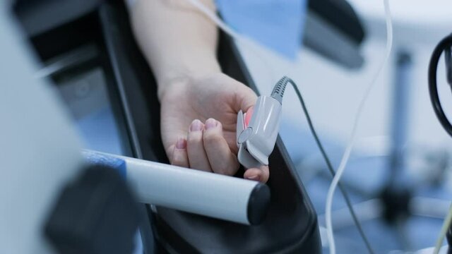 Operation of removing tonsils, deep anesthesia, latest devices, cold plasma method, cuts swelling in throat, doctor works with new probe, medical headlamp, surgical loupes, patient with pulse oximetr