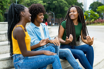 Group of talking african american male and female young adults