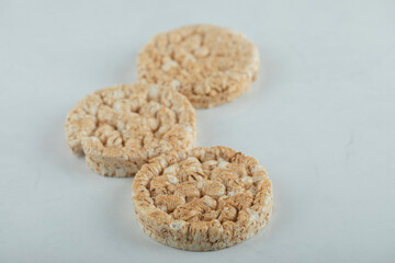 Delicious round crispbread on light gray background