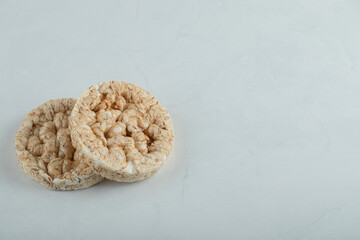 Tasty round crispbread on lighht gray background