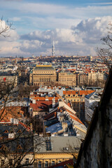 Fototapeta premium Panorama aerial view of Old town cityscape from Petrin Hill, building of national theater, red roofs and Zizkov television tower in background, sunny day, Prague, Czech Republic