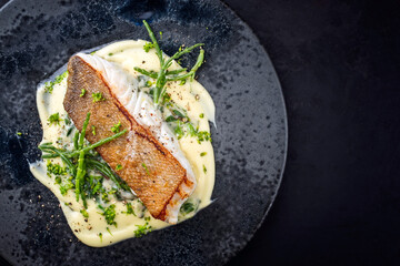 Modern style traditional fried skrei cod fish filet with mashed potatoes and glasswort served as...