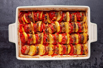 Baked in layers and rows slices of meatballs, potatoes, tomatoes and peppers. Traditional...