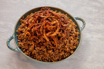 Lentil and bulgur pilaf with fried onion on the top. Palestinian cuisine.