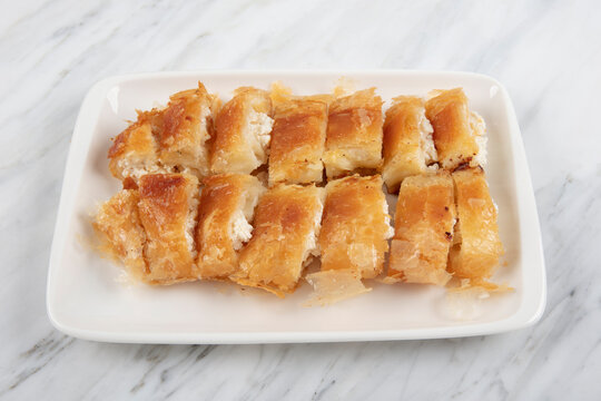 Turkish Style Meat Stuffed Filo Dough Borek Served Kol Boregi. Cheese And Minced Pie Are Sliced On A Marble Background. Turkish Name: Kol Boregi.