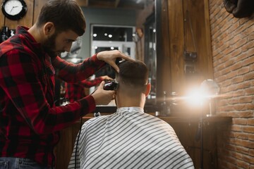Serious Young Bearded Man Getting Haircut By Barber. Barbershop Theme